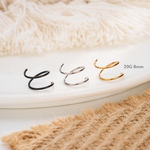 May include: Three spiral ear cuffs in black, silver, and gold. The ear cuffs are 8mm in size and are made of 20 gauge metal.
