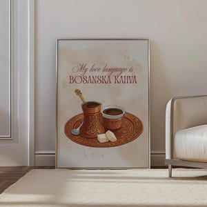 May include: A framed wall art print featuring a brown coffee pot, a small cup, a spoon, and two sugar cubes on a decorative tray. The text reads My love language is BOSANSKA KAHVA. The illustration uses warm brown and beige tones on a light background.