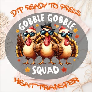 May include: A DTF heat transfer design featuring three turkeys wearing black sunglasses, with the center turkey wearing a black hat. The text reads GOBBLE GOBBLE SQUAD, surrounded by orange and yellow autumn leaves on a gray circular background.