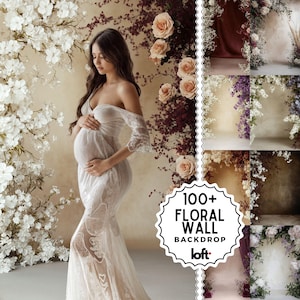May include: A pregnant person in a white lace gown, posing in front of a floral backdrop. The backdrop features white and peach-colored flowers. The image includes the text "100+ FLORAL WALL BACKDROP loft."