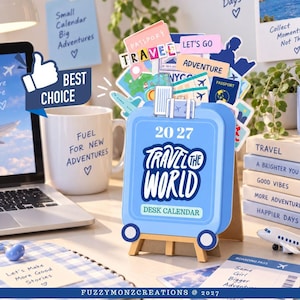 May include: A 2027 desk calendar shaped like a light blue suitcase with the text Travel The World. The calendar features a pop-up design with various travel-themed illustrations including passports, airplanes, and luggage, all displayed on a small wooden easel stand.