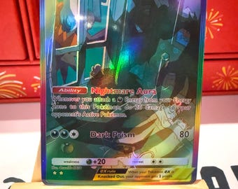May include: A holographic Pokemon trading card featuring Darkrai EX, a dark-type Pokemon with a purple and black color scheme. The card has a HP of 140 and an ability called Nightmare Aura. The card also has a move called Dark Prism that does 80 damage.