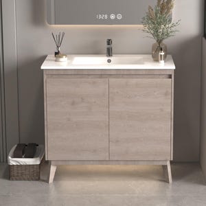 May include: A light wood bathroom vanity with a white porcelain sink and two cabinet doors. The vanity has a modern design with sleek lines and a minimalist aesthetic.