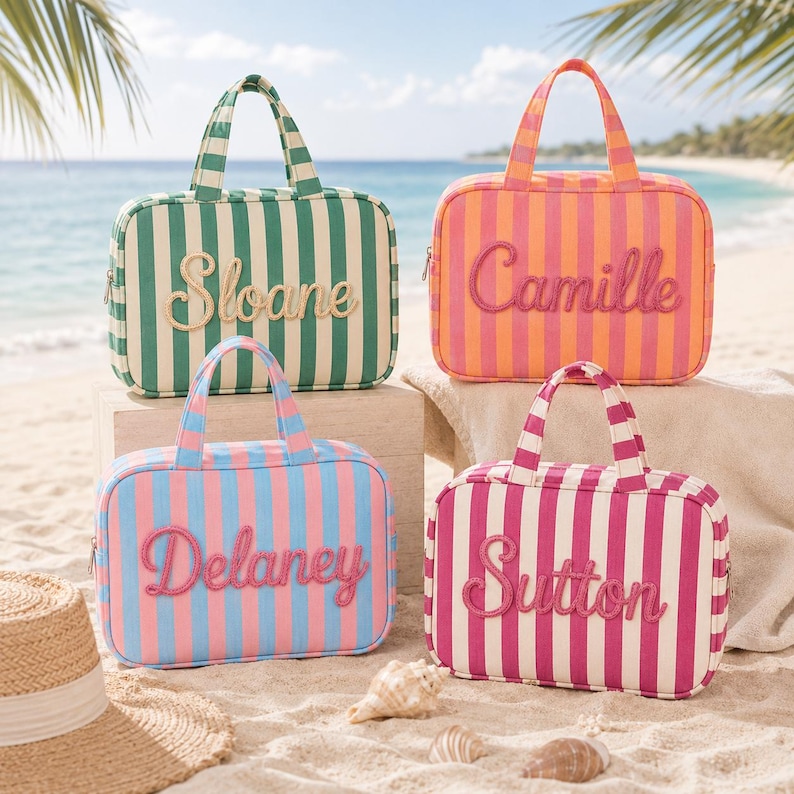 May include: Four rectangular zippered travel bags with top handles, each featuring vertical stripes and a name embroidered in cursive script on the front. The bags are colored in green and white, orange and pink, blue and pink, and magenta and white.