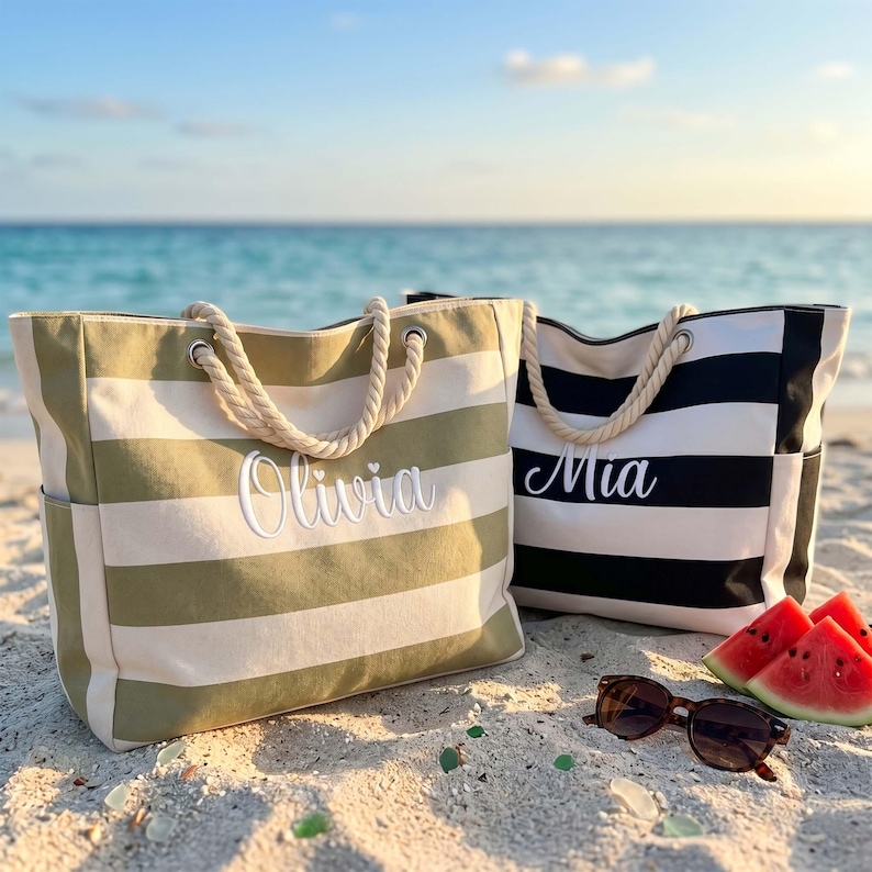 May include: Two canvas tote bags with rope handles. One bag features olive green and white horizontal stripes with the name Olivia embroidered in white. The other bag has black and white horizontal stripes with the name Mia embroidered in white.
