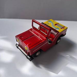 Charming Nostalgic Vintage  Tin Toy: Red Jeep - Classic Collectible Treasure