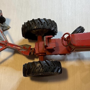 Red ERTL Steerable Die Cast Toy Tractor in USED condition, Vintage Collectible IH, plastic wheels
