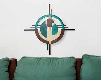 May include: A teal, brown, and beige abstract wall art sculpture with a circular design. The sculpture is made of wood and has a modern, geometric style.