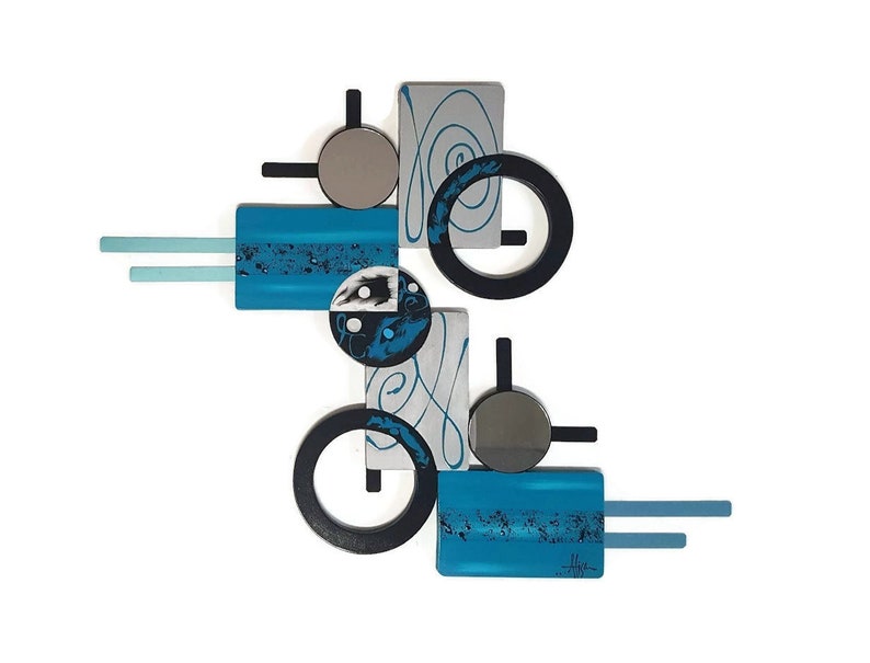 May include: Abstract wall art with geometric shapes in shades of blue, black, silver, and white. The piece features circles, squares, and rectangles with a swirling design.