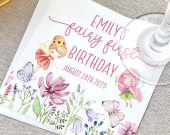 May include: Square paper napkin with a floral and fairy design. The napkin has the text "EMILY'S fairy first BIRTHDAY AUGUST 28TH 2025". The design includes fairies, butterflies, and flowers in pink, purple, and green.