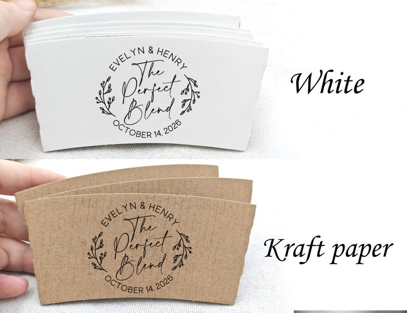 May include: White and kraft paper coffee cup sleeves with the text "EVELYN & HENRY The Perfect Blend OCTOBER 14, 2026" printed in black. The design includes a floral wreath. The sleeves are shown in a stack.