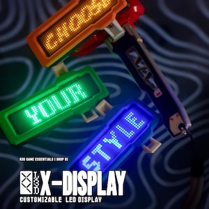 May include: Three X-DISPLAY customizable LED displays are shown, in orange, green, and blue. The orange display reads "CHOOSE", the green display reads "YOUR", and the blue display reads "STYLE". The product is labeled "R3D GAME ESSENTIALS | DROP 01".
