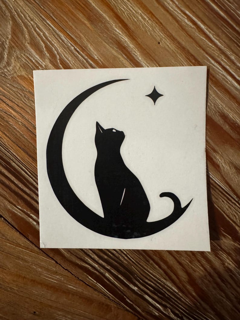 May include: Black silhouette of a cat sitting on a crescent moon with a star above it. The design is on a white background.