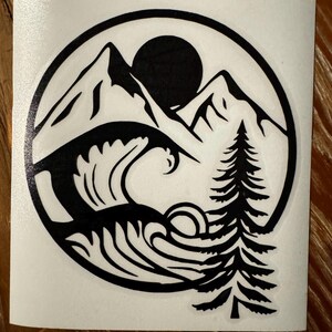 May include: Black and white sticker design featuring a mountain range, a wave, a pine tree, and a sun. The design is enclosed in a circle.