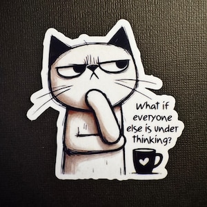May include: A white cat sticker with black ears and a grumpy expression, pondering with its paw on its chin. The sticker includes the text "What if everyone else is under thinking?" and a coffee cup with a heart.