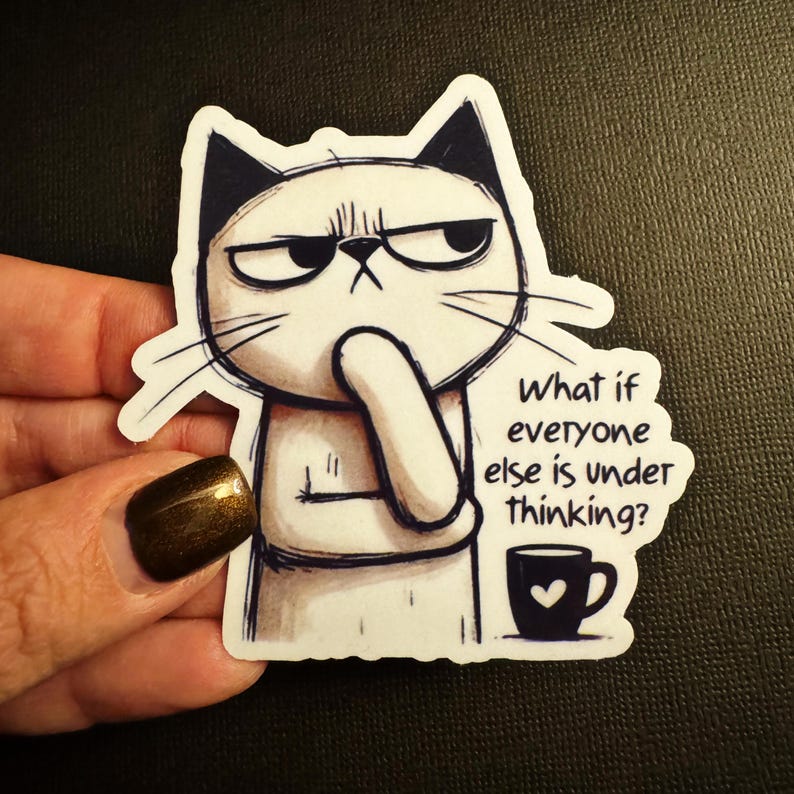 May include: A white sticker featuring a grumpy cat with black ears and eyebrows, pondering with its paw on its chin. The sticker includes the text "What if everyone else is under thinking?" and a small coffee cup.