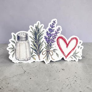 May include: A die-cut sticker featuring a detailed illustration of a salt shaker, a sprig of green rosemary, a bundle of purple lavender tied with a tan ribbon, and a hand-drawn red heart outline, all arranged together on a white background.