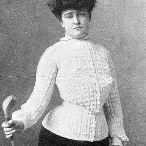 May include: A black and white photo of a woman wearing a white, crocheted blouse and a dark skirt. She is holding a golf club in her right hand.
