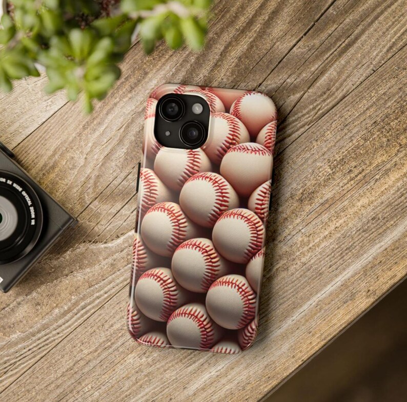 May include: A white and red baseball phone case with a close-up image of baseballs.