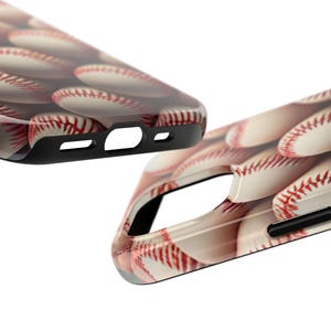 May include: A phone case with a baseball pattern. The case is black and has a raised edge around the camera lens.