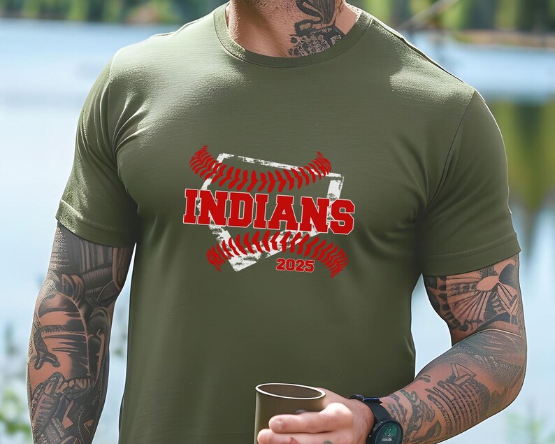 May include: A green t-shirt with a white baseball diamond graphic and red stitching. The text "INDIANS" is in red letters and the year "2025" is below the diamond.