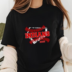 May include: Black t-shirt with a red and white baseball graphic. The graphic features the word "INDIANS" and the year "2023".
