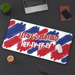 May include: A white mousepad with red and blue brushstrokes and the text "Let's Go Buffalo Hey-Ey-Ey-Ey".