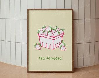 Può includere: Una stampa incorniciata con un disegno di fragole in un cestino di bacche bianco e rosso. Le fragole hanno steli verdi. Le parole "les fraises" sono scritte in verde sotto il cestino. Lo sfondo è di colore giallo chiaro.