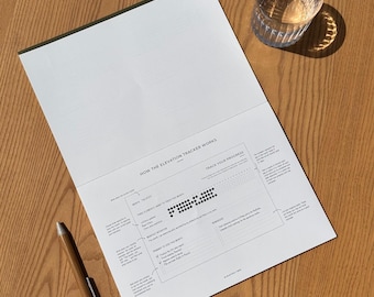 May include: A white sheet of paper with instructions on how to use an elevation tracker. The paper has a grid with black dots and a section for tracking progress. The text "HOW THE ELEVATION TRACKER WORKS" and "TRACK YOUR PROGRESS" is printed on the paper.