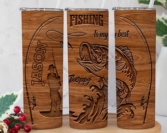 May include: Wooden tumbler with a fishing theme. The tumbler features engraved text and images, including a fisherman, a fish, and the words "FISHING is my best therapy." The name "JASON" is also engraved on the tumbler.