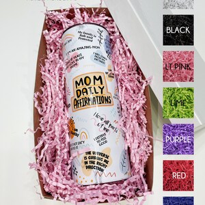 May include: White gift box with pink crinkle paper and a white tumbler with the text "Mom Daily Affirmations" and colorful designs. The box is surrounded by color swatches of white, black, light pink, lime, purple, red, and blue.