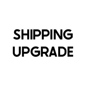 May include: Black and white text that reads "SHIPPING UPGRADE".