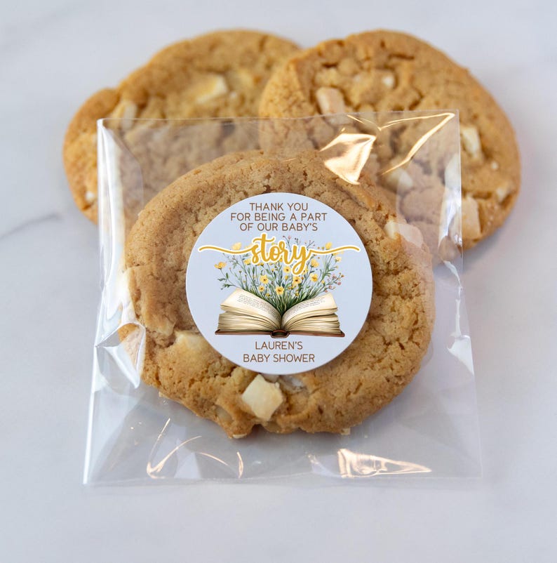 May include: A clear plastic bag filled with cookies and a round sticker that says "Thank you for being a part of our baby's story. Lauren's Baby Shower". The sticker has a yellow and white floral design with an open book in the center.