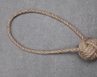 May include: A brown rope toy with a knotted ball at the end.