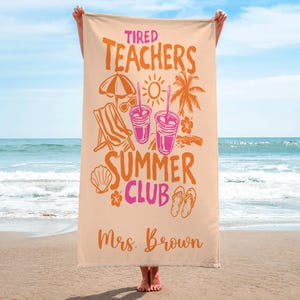 May include: A beige beach towel with the words "Tired Teachers Summer Club" in orange and pink. The towel features illustrations of a beach umbrella, sunglasses, a beach chair, drinks, and a palm tree. The name "Mrs. Brown" is printed at the bottom.