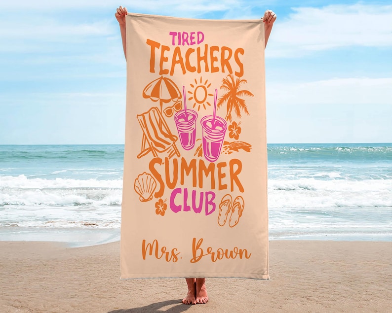 May include: A beige beach towel with the words "Tired Teachers Summer Club" in orange and pink. The towel features illustrations of a beach umbrella, sunglasses, a beach chair, drinks, and a palm tree. The name "Mrs. Brown" is printed at the bottom.
