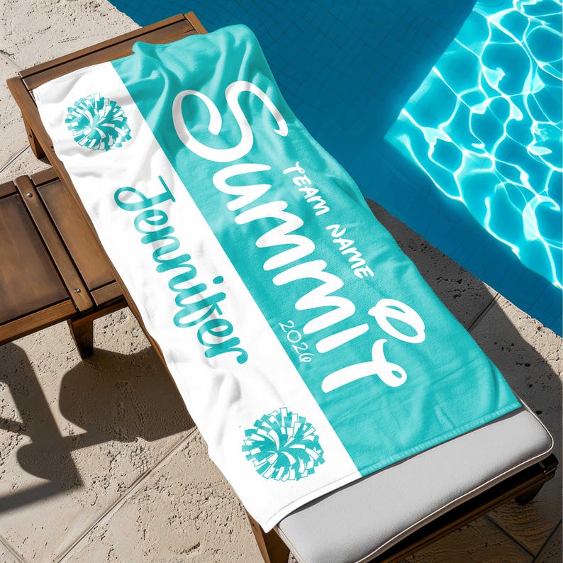 May include: A personalized beach towel with a teal and white design. The towel features the name "Summit" in large white script, the name "Jennifer" in teal script, and the year "2020". Two teal pom-pom graphics are also visible.