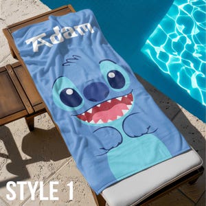 May include: Blue beach towel with a cartoon Stitch character and the name "Adam" printed in white.
