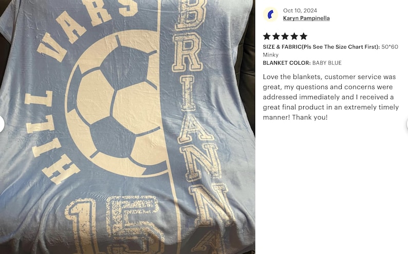 May include: Baby blue blanket with white text and a soccer ball graphic. The blanket features the name "BRIAN" vertically and "VARSITY HILL 15" in a circular design. The blanket measures 50x60 inches.