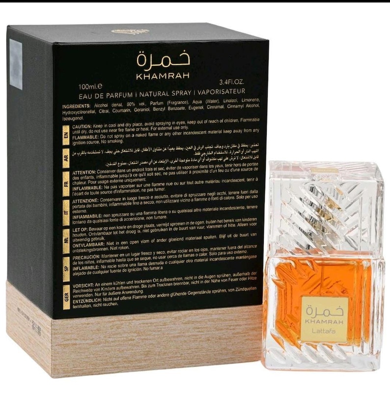 May include: A rectangular black and tan perfume box labeled Khamrah with 100ml and 3.4 fl. oz. text, alongside a clear glass perfume bottle with a textured geometric pattern and an amber-colored liquid, featuring a square label with Khamrah Lattafa text.