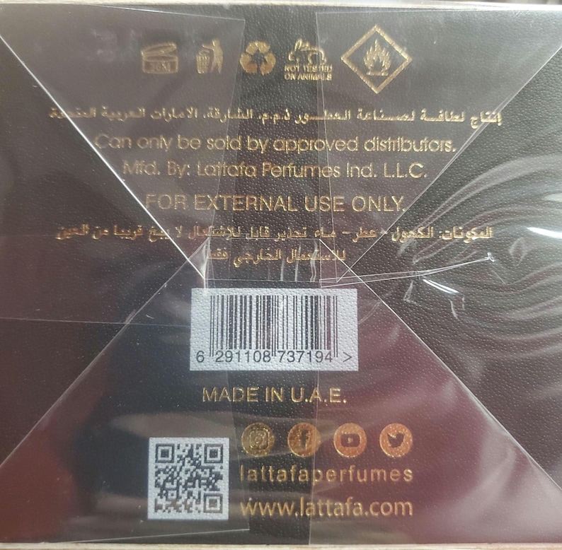 May include: A black rectangular perfume box with gold text and symbols. The back features the text Can only be sold by approved distributors, Mfd. By: Lattafa Perfumes Ind. L.L.C., FOR EXTERNAL USE ONLY, MADE IN U.A.E., and a barcode with the number 6 291108 737194.
