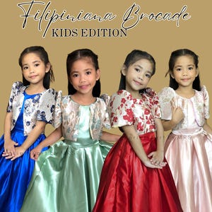 May include: Four young girls wearing Filipiniana Brocade dresses. Each dress features a satin skirt in blue, green, red, and pink. The tops have floral brocade boleros with puffed sleeves. The image has the text "Filipiniana Brocade KIDS EDITION".