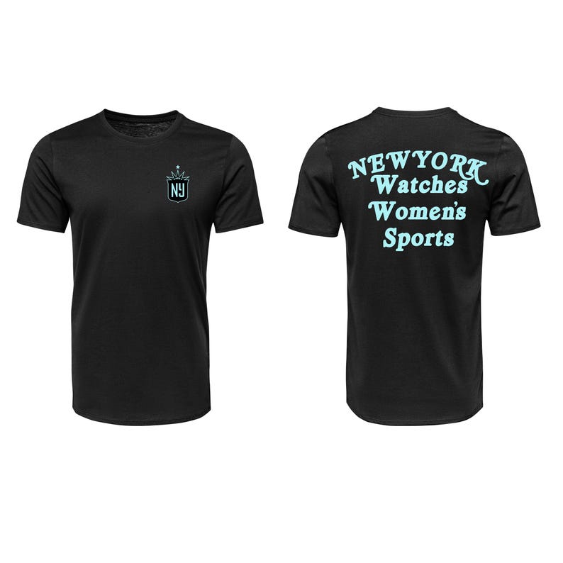 May include: Black t-shirt with a light blue crown and "NY" logo on the front. The back of the shirt features the words "NEW YORK Watches Women's Sports" in light blue. A casual tee for sports fans.