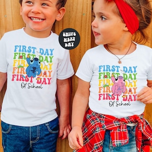 two young children standing next to each other