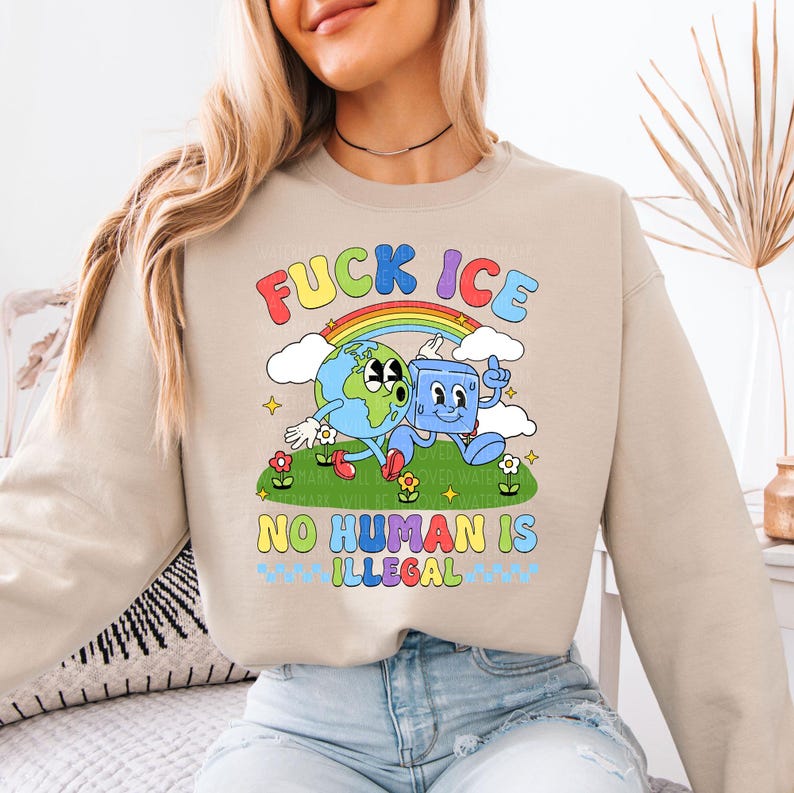 a woman sitting on a bed wearing a sweatshirt that says fucking ice no human is