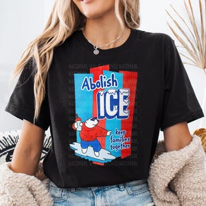 a woman wearing a black t - shirt with an ice advertisement on it