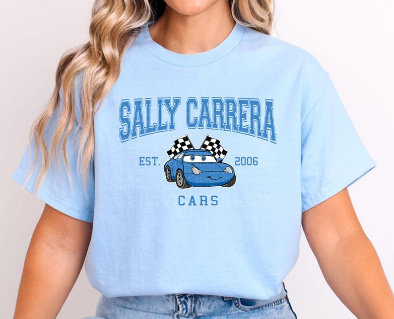 a woman wearing a blue t - shirt with a car on it