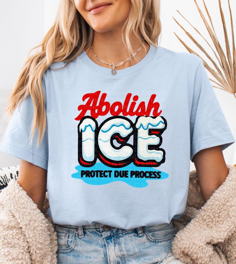 a woman wearing a blue shirt that says abollish ice