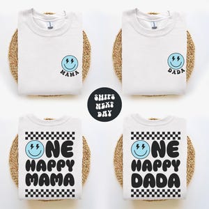 four white t-shirts with black text and a blue smiley face design, arranged in a grid pattern.