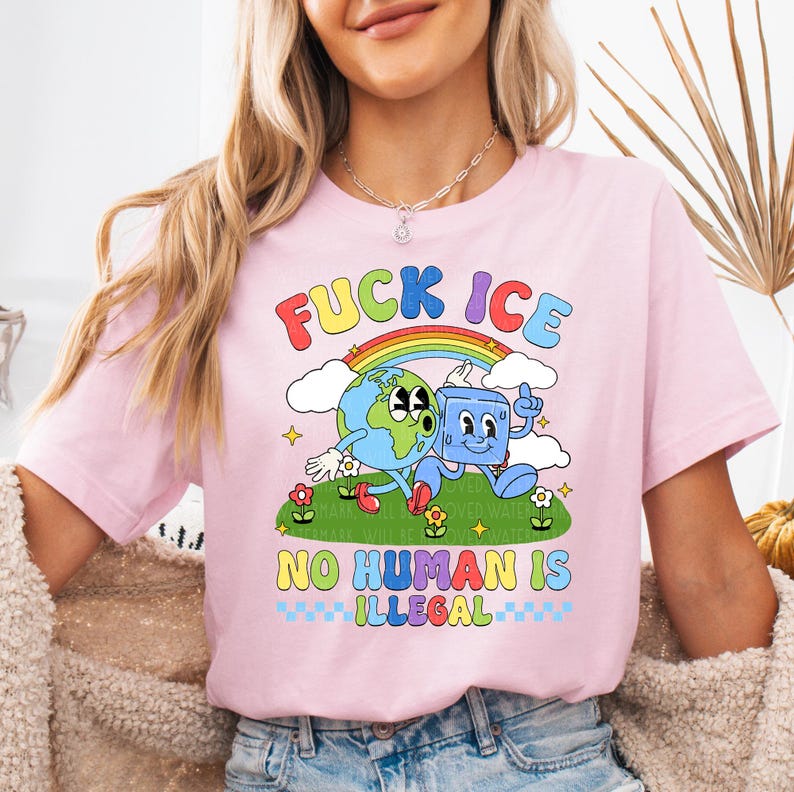 a woman wearing a pink t - shirt with a cartoon character on it